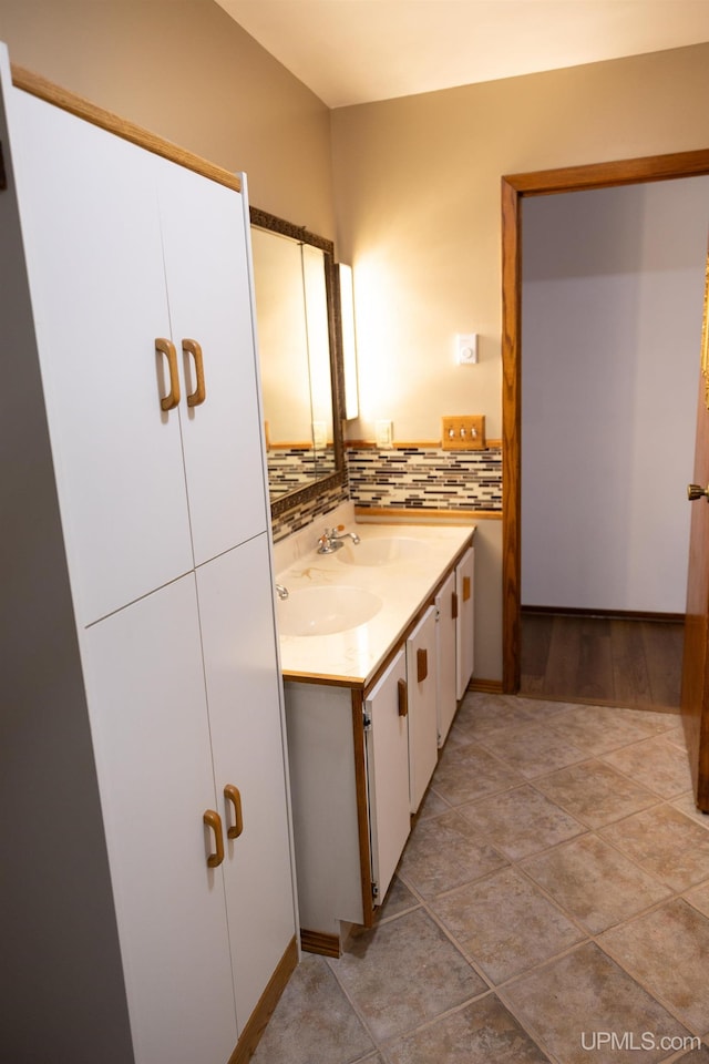 bathroom with hardwood / wood-style floors, backsplash, and vanity