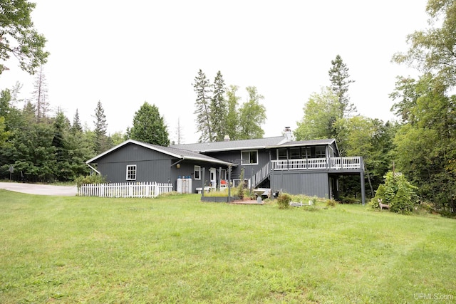 rear view of property featuring a yard