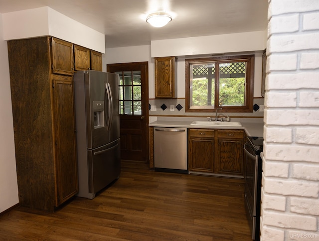 kitchen featuring dark wood-type flooring, sink, appliances with stainless steel finishes, and decorative backsplash