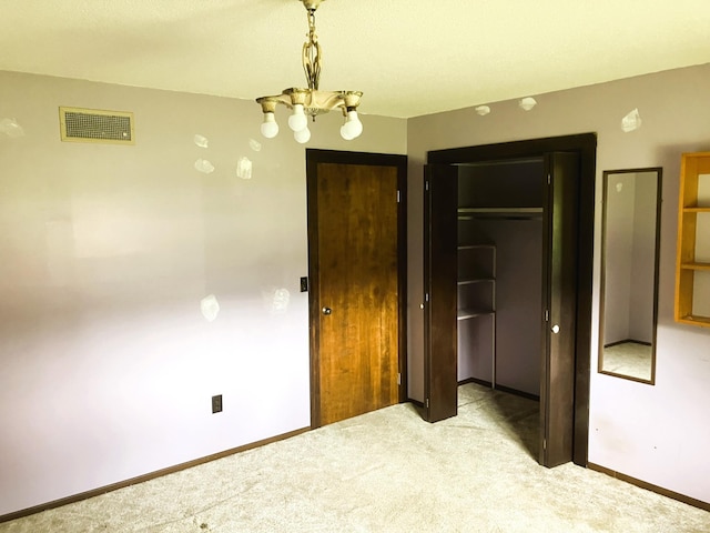 carpeted bedroom featuring an inviting chandelier