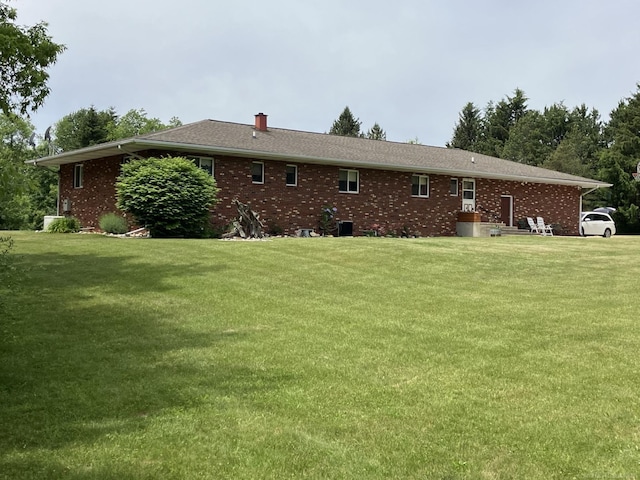 rear view of property with a lawn