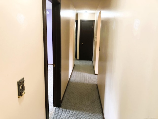 corridor featuring light colored carpet