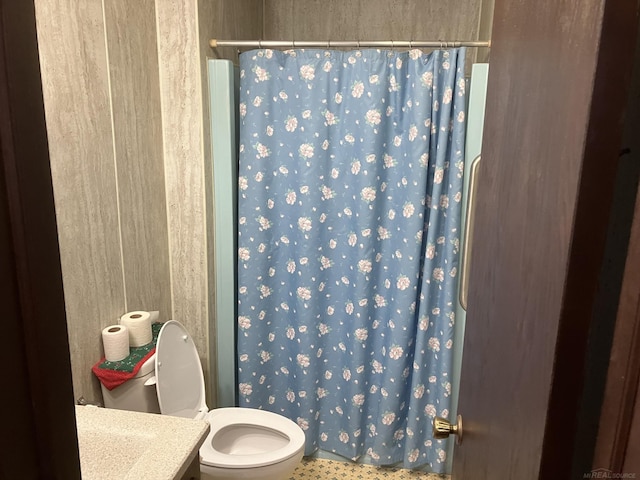 bathroom featuring vanity, curtained shower, and toilet