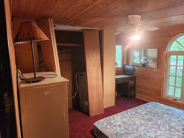 carpeted bedroom featuring wood ceiling, ceiling fan, and wood walls