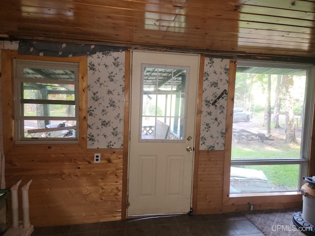 entryway featuring wood ceiling, plenty of natural light, and wood walls