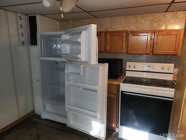 kitchen with white appliances, ceiling fan, and a drop ceiling