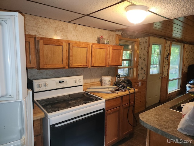 kitchen featuring dark tile patterned floors and white electric range