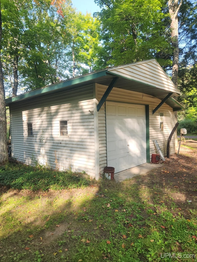 view of property exterior featuring an outbuilding and a garage