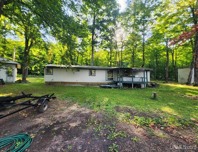 back of property featuring a yard and a deck