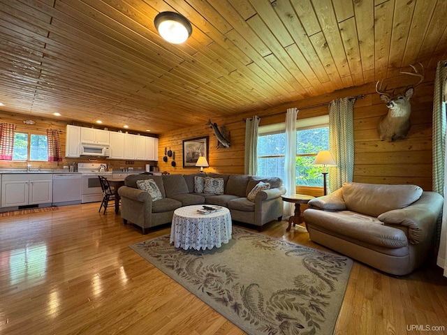 living room featuring sink, light wood-type flooring, and wooden ceiling