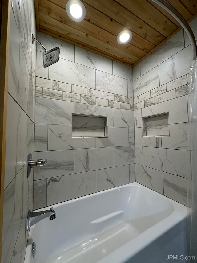 bathroom featuring tiled shower / bath and wood ceiling