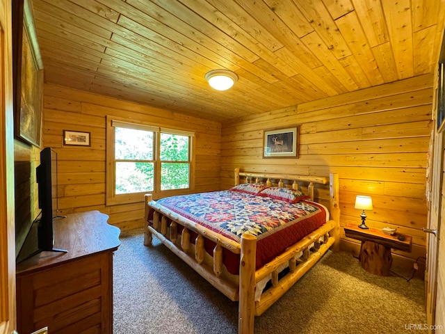 carpeted bedroom with wood walls and wooden ceiling