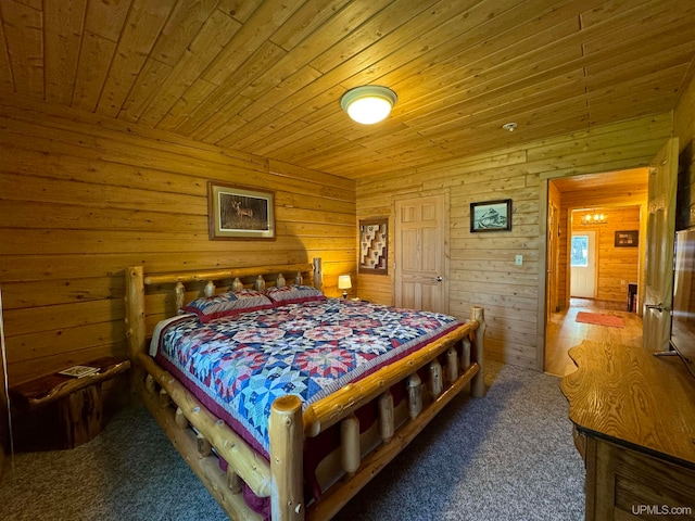 bedroom with wooden ceiling, wood walls, and carpet flooring