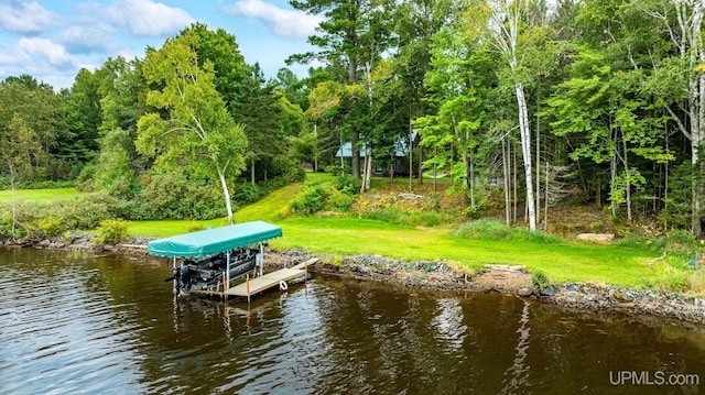 dock area featuring a water view and a lawn