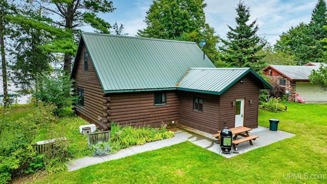 exterior space with a front lawn and a patio