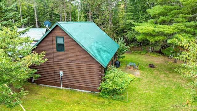 view of side of home with a yard