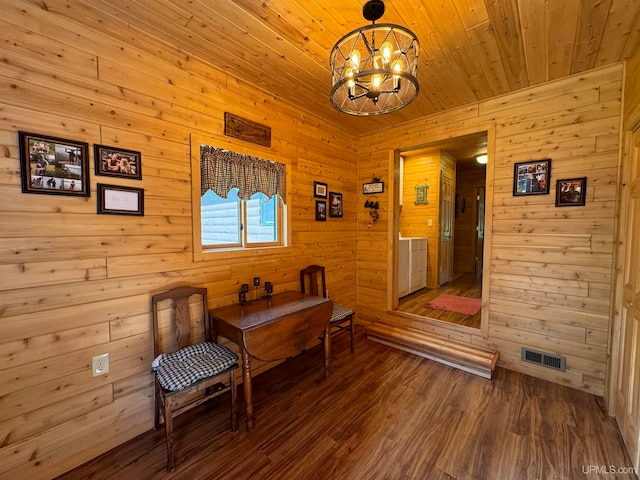 living area with hardwood / wood-style floors, a chandelier, wood walls, and wooden ceiling