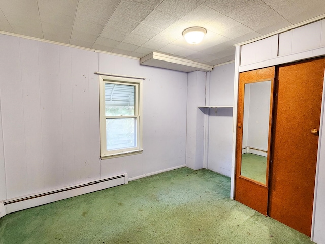 unfurnished bedroom featuring a baseboard radiator, carpet, and a closet