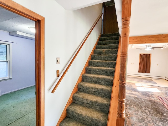 stairway with a baseboard radiator