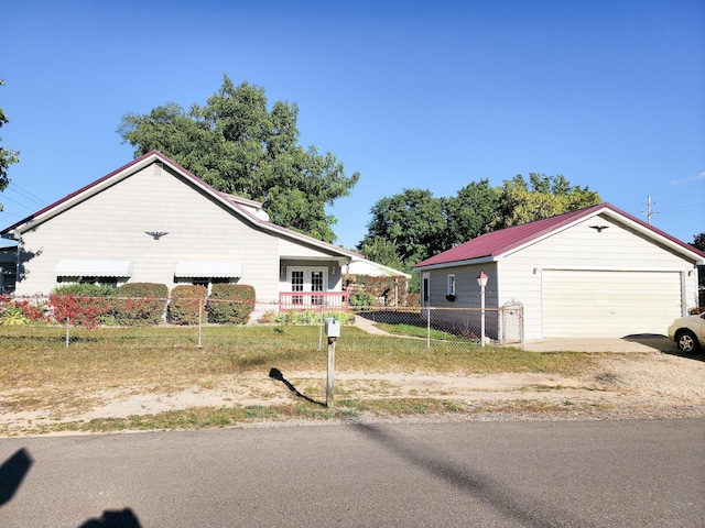 295 W Birch St, Harrison, MI 48625 - view of front facade featuring a detached garage