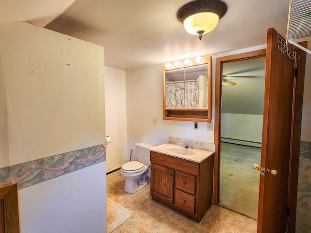 bathroom featuring vanity, baseboard heating, and toilet