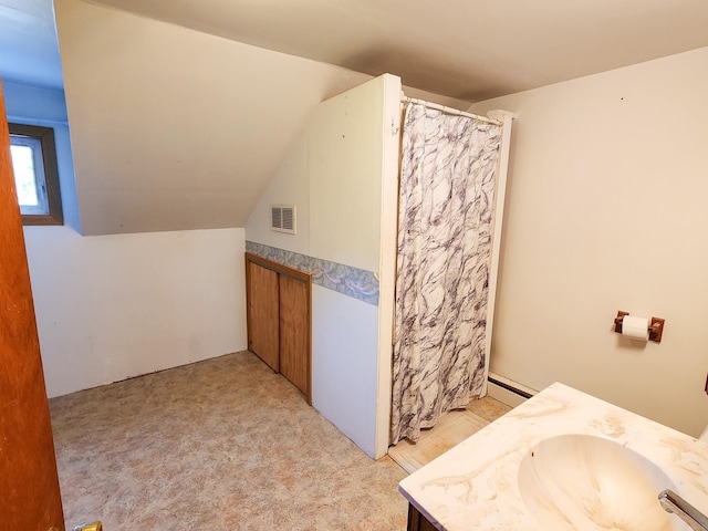 295 W Birch St, Harrison, MI 48625 - bathroom featuring vanity, lofted ceiling, a shower with shower curtain, and a baseboard radiator