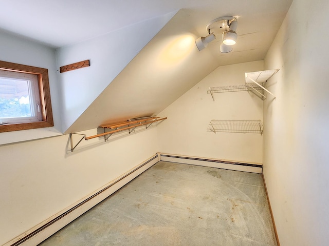 walk in closet with baseboard heating and vaulted ceiling