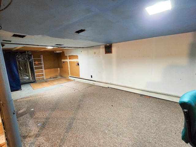 295 W Birch St, Harrison, MI 48625 - unfinished below grade area with a baseboard heating unit and carpet floors