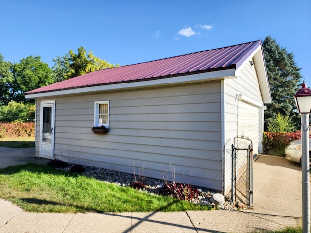 295 W Birch St, Harrison, MI 48625 - view of side of property with an outdoor structure and a metal roof