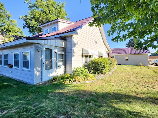 view of side of property with a yard