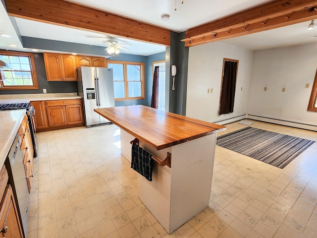 295 W Birch St, Harrison, MI 48625 - kitchen with appliances with stainless steel finishes, light floors, butcher block countertops, a ceiling fan, and beamed ceiling