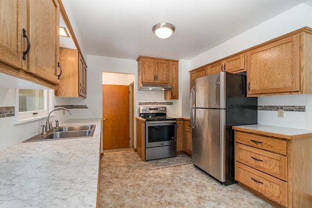 kitchen featuring appliances with stainless steel finishes, backsplash, and sink