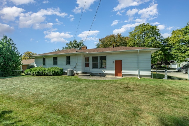 back of house featuring central air condition unit, a yard, and a patio