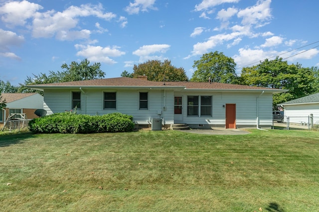 rear view of property featuring a patio area, a yard, and central air condition unit