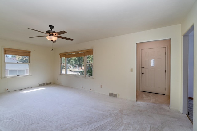 carpeted empty room featuring ceiling fan