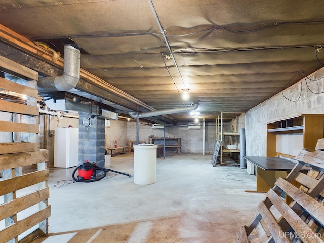 basement featuring white fridge