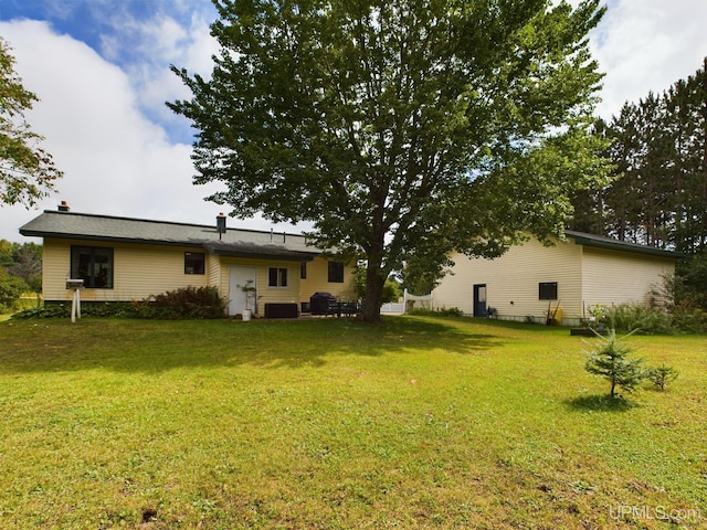 rear view of house with a yard