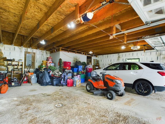 garage with a garage door opener and electric panel