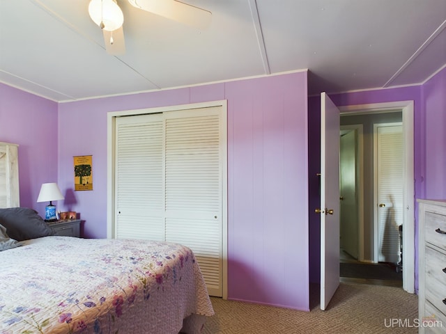 carpeted bedroom with ceiling fan and a closet