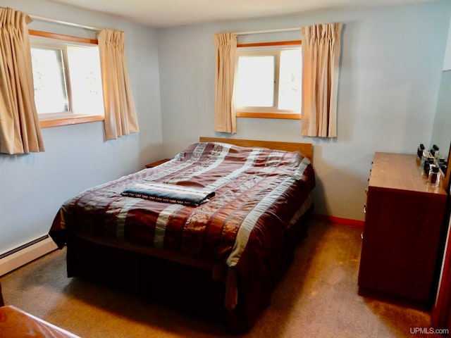 carpeted bedroom with a baseboard heating unit and multiple windows