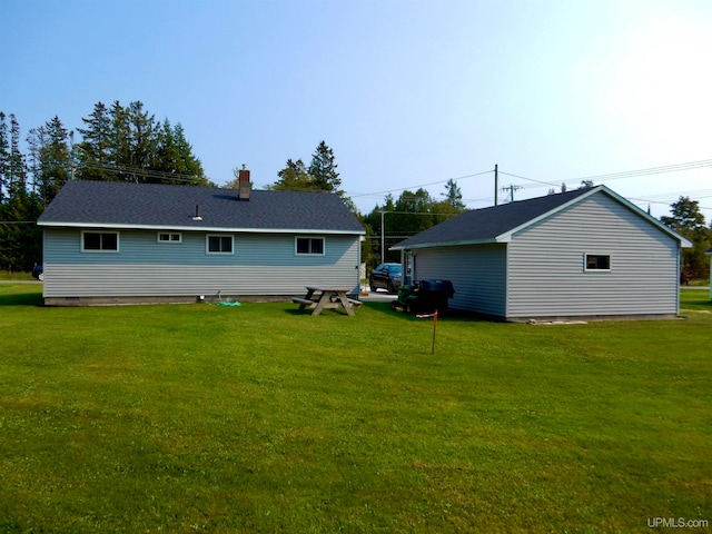 rear view of property featuring a yard