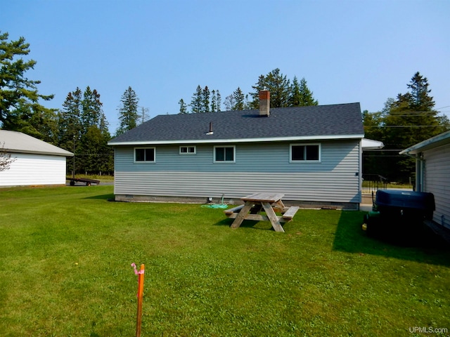 rear view of house with a yard and a patio area