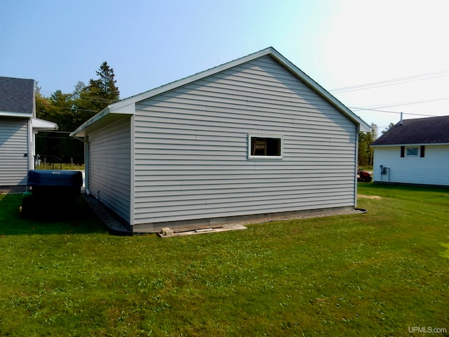 view of side of home with a lawn