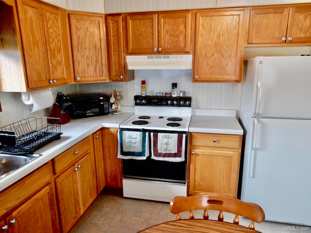 kitchen with white appliances and decorative backsplash