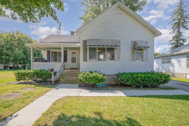 bungalow-style home with a front yard