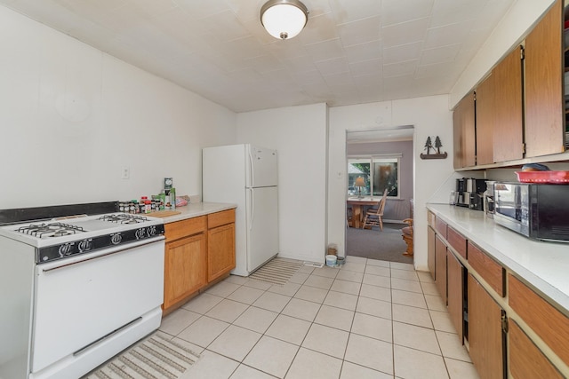 kitchen featuring white appliances and light tile patterned flooring