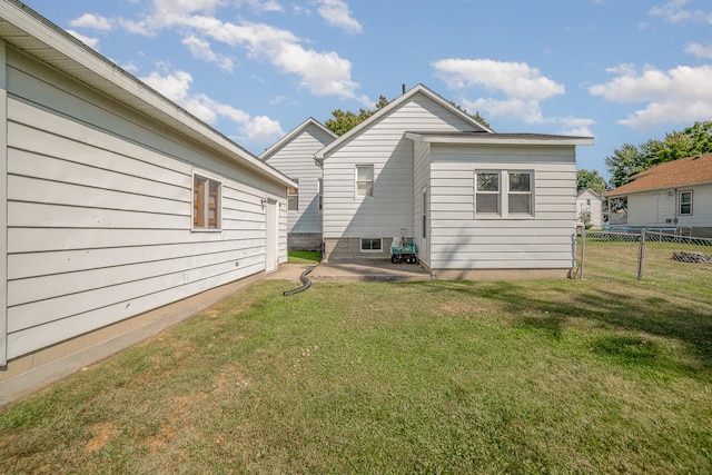 back of property featuring a patio area and a yard