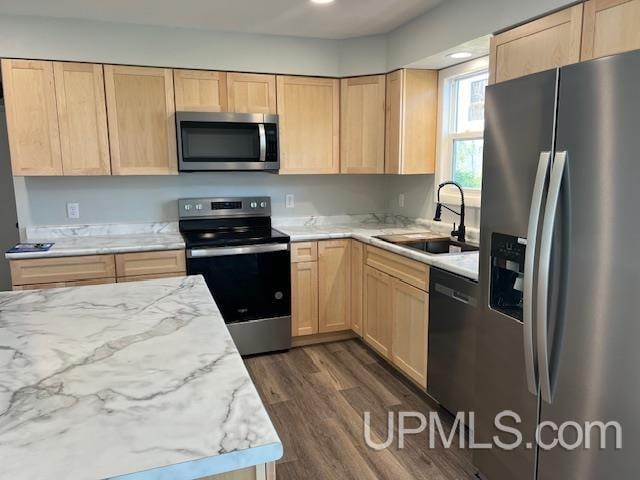 kitchen with light brown cabinets, sink, appliances with stainless steel finishes, and dark wood-type flooring