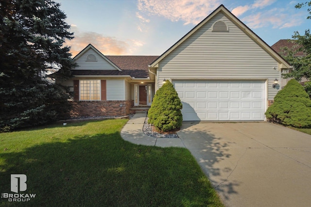 single story home with a yard and a garage