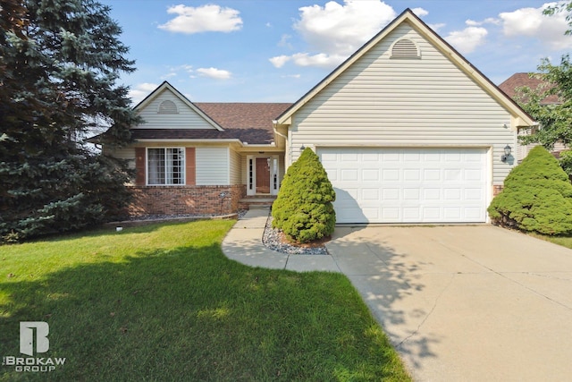 view of front of home with a front yard and a garage